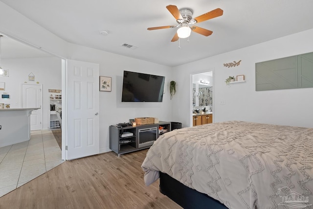 80 Woodland St, Cantonment, FL 32533 - bedroom with light wood-style floors, a ceiling fan, and connected bathroom
