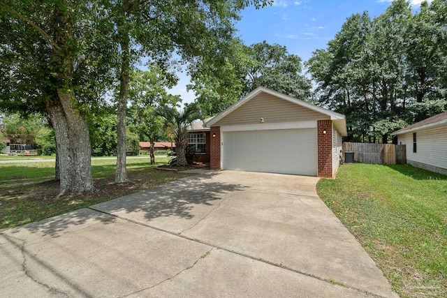 80 Woodland St, Cantonment, FL 32533 - view of front of home featuring driveway, an attached garage, and brick siding