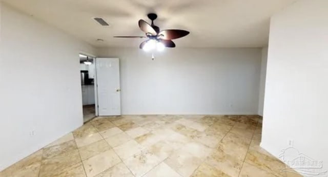 unfurnished room featuring ceiling fan and visible vents