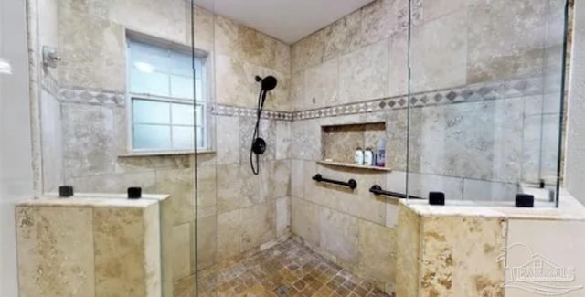 bathroom with tiled shower