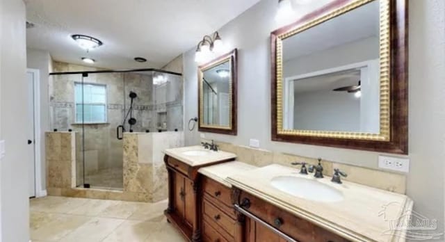 full bathroom with a shower stall and vanity