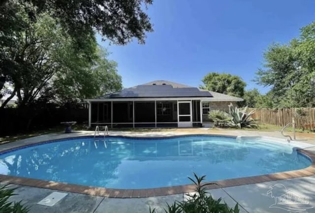 view of pool featuring a sunroom, a fenced in pool, and fence