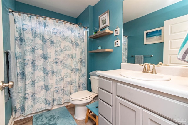 bathroom with curtained shower, wood-type flooring, vanity, and toilet