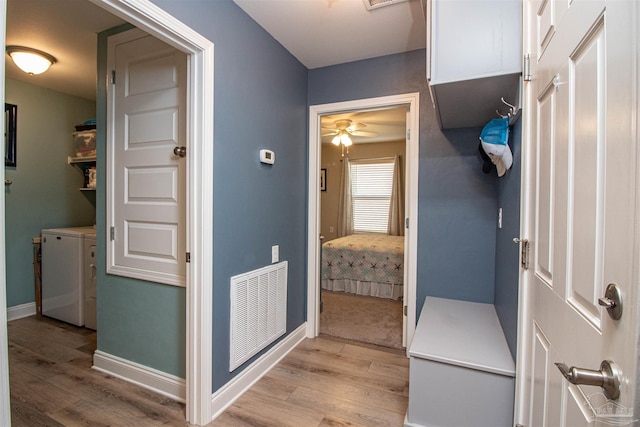 bathroom featuring ceiling fan, washer and dryer, and hardwood / wood-style flooring