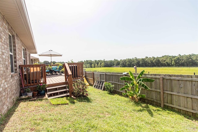 view of yard with a rural view and a deck