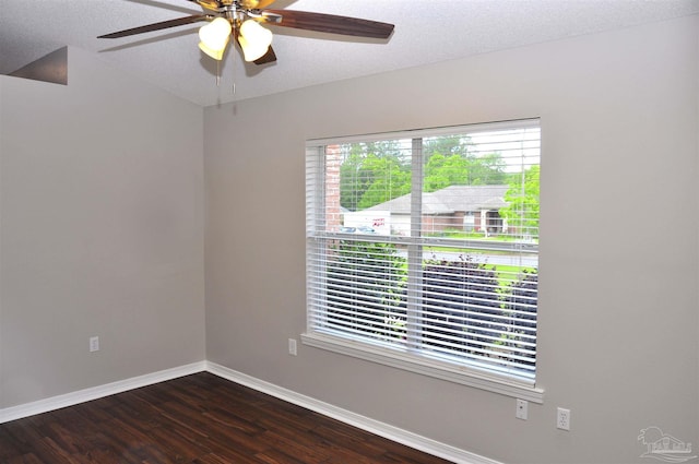 1701 Eagle Ter, Cantonment, FL 32533 - unfurnished room with baseboards, a ceiling fan, a textured ceiling, and dark wood-type flooring