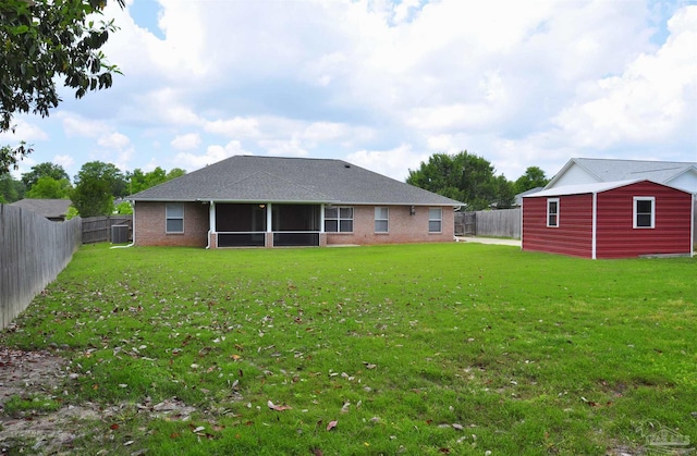1701 Eagle Ter, Cantonment, FL 32533 - rear view of house featuring a fenced backyard, a yard, a sunroom, and brick siding