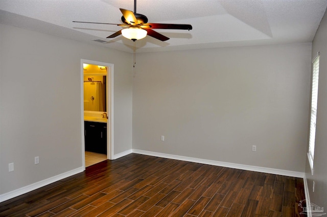 1701 Eagle Ter, Cantonment, FL 32533 - unfurnished room with visible vents, baseboards, ceiling fan, dark wood-style floors, and a sink