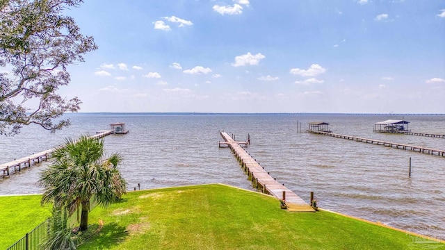 dock area with a yard and a water view