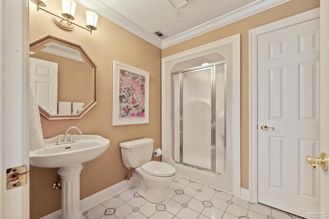 bathroom with a shower with door, a textured ceiling, toilet, and tile patterned flooring