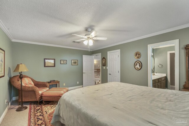 bathroom featuring crown molding, a textured ceiling, double vanity, and tile patterned flooring