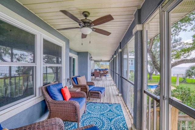 sunroom / solarium featuring ceiling fan