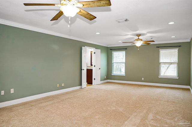 empty room featuring crown molding, light carpet, and ceiling fan