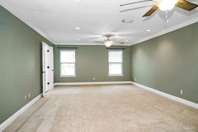 carpeted spare room featuring ornamental molding and ceiling fan