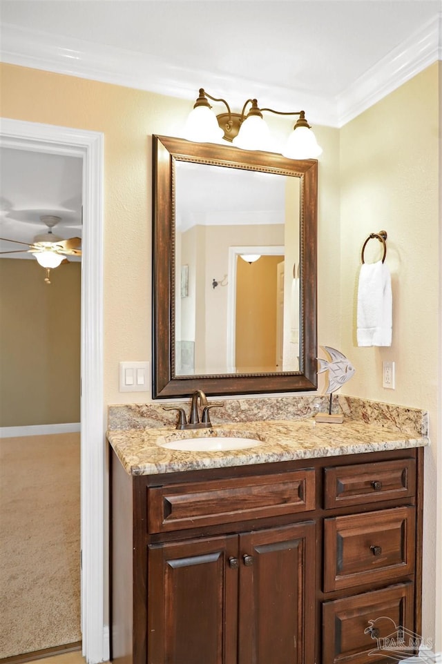 bathroom with vanity, ornamental molding, and ceiling fan