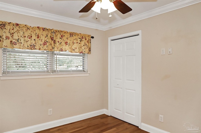 unfurnished bedroom with crown molding, hardwood / wood-style flooring, a closet, and ceiling fan