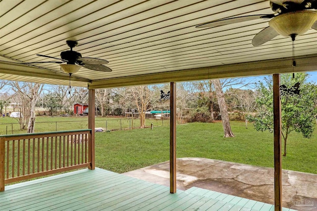 wooden deck with ceiling fan and a lawn