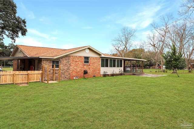 rear view of property featuring a yard and a patio area