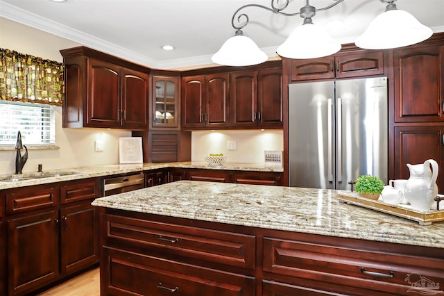 kitchen with sink, crown molding, pendant lighting, stainless steel appliances, and light stone countertops