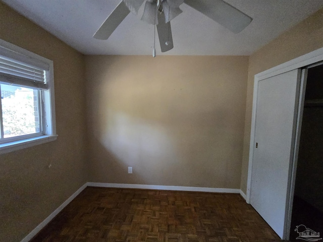 spare room featuring dark parquet floors