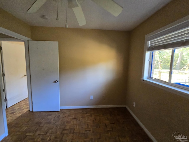 empty room featuring dark parquet flooring and a textured ceiling