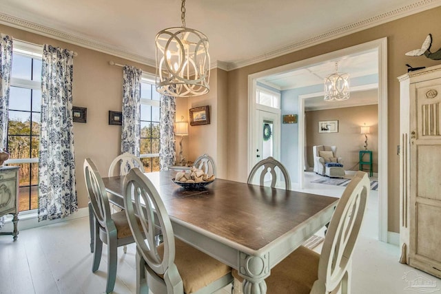 dining room featuring crown molding and a chandelier