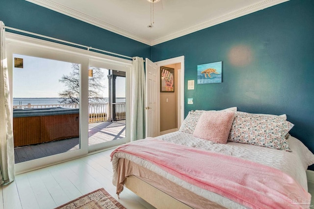 bedroom with access to exterior, a water view, ornamental molding, and hardwood / wood-style floors