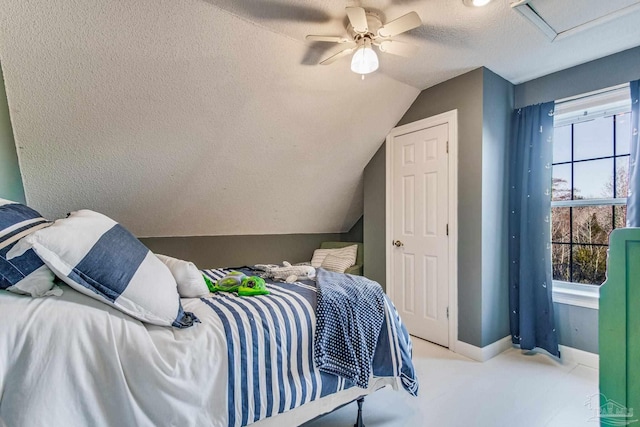 bedroom featuring ceiling fan, a textured ceiling, and lofted ceiling