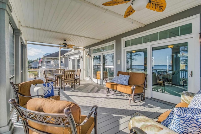 sunroom / solarium featuring ceiling fan