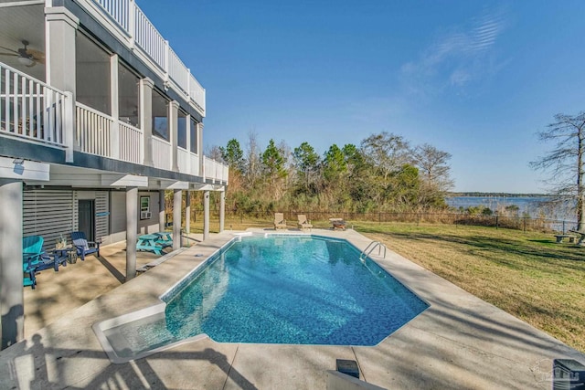 view of swimming pool with a yard and a patio