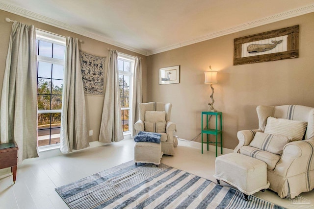 sitting room featuring hardwood / wood-style flooring and ornamental molding