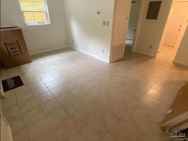 spare room with light tile patterned floors and electric panel