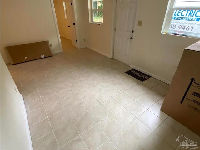 entryway with light tile patterned flooring