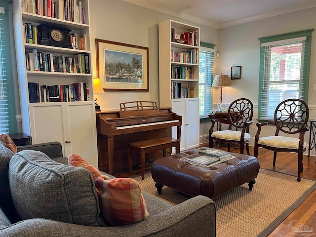 sitting room featuring crown molding, wood-type flooring, and plenty of natural light