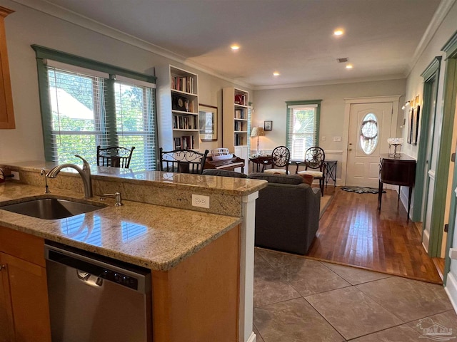 kitchen with light hardwood / wood-style floors, ornamental molding, sink, and stainless steel dishwasher