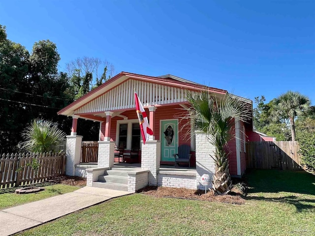 view of front of home with a front yard and a porch