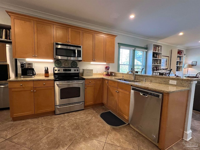 kitchen with appliances with stainless steel finishes, kitchen peninsula, ornamental molding, and sink