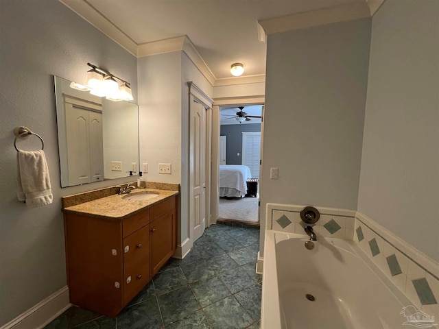 bathroom with a bathing tub, ceiling fan, ornamental molding, vanity, and tile patterned floors