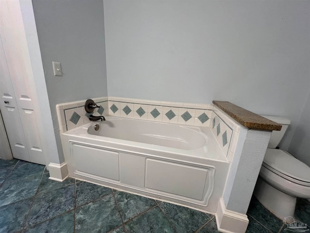 bathroom with toilet, tile patterned flooring, and a washtub