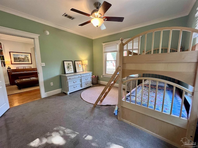 carpeted bedroom featuring ornamental molding, a fireplace, and ceiling fan