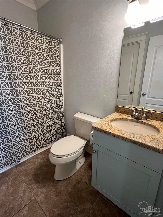 bathroom featuring vanity, toilet, and tile patterned flooring