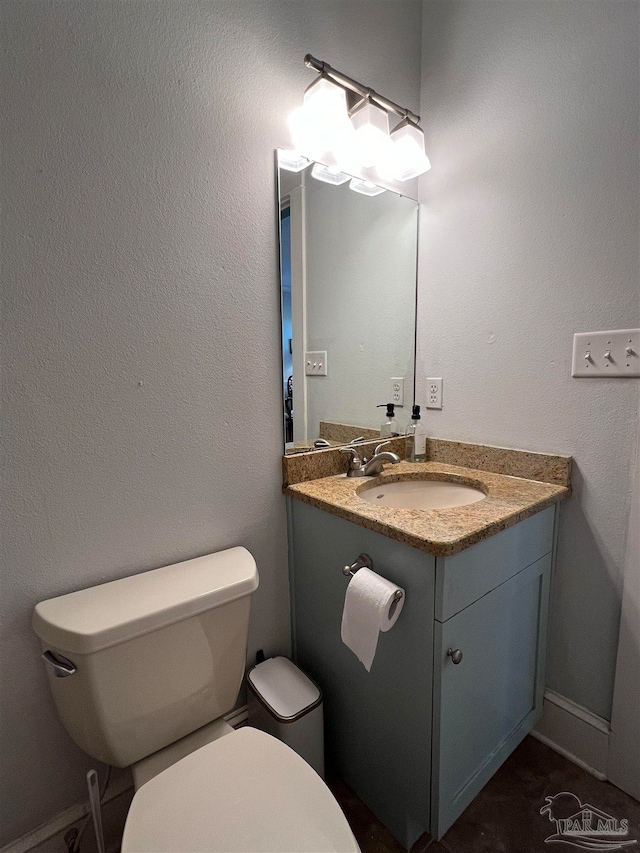 bathroom with toilet and vanity