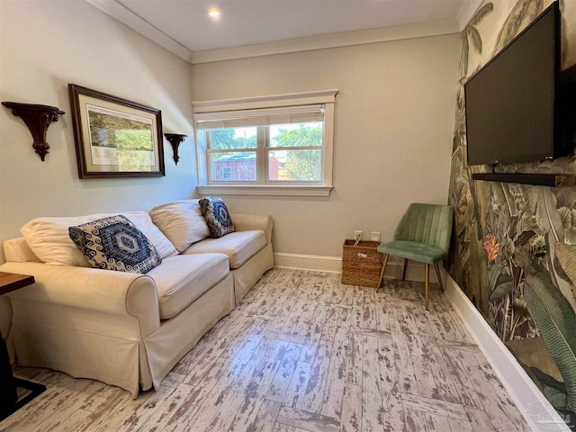 living area with crown molding and light wood-type flooring