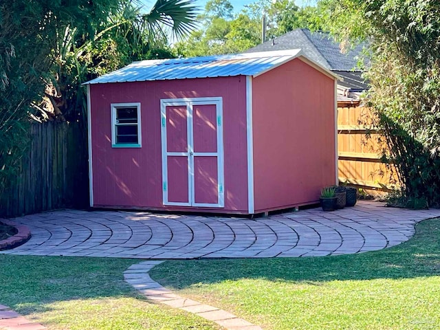 view of outdoor structure featuring a lawn