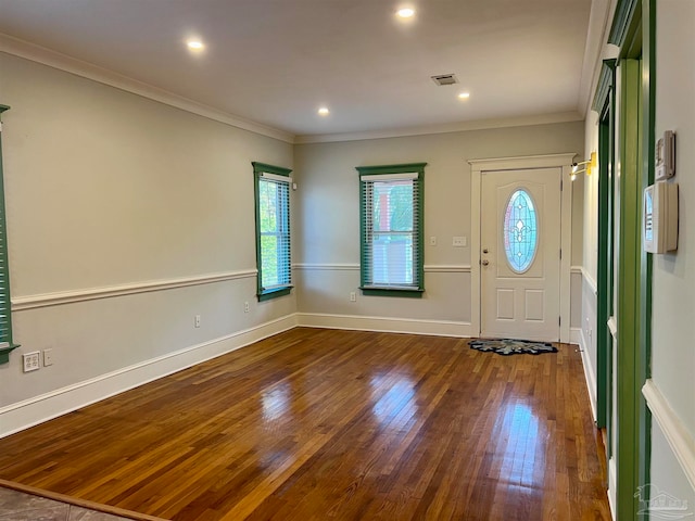 foyer entrance with crown molding and wood-type flooring