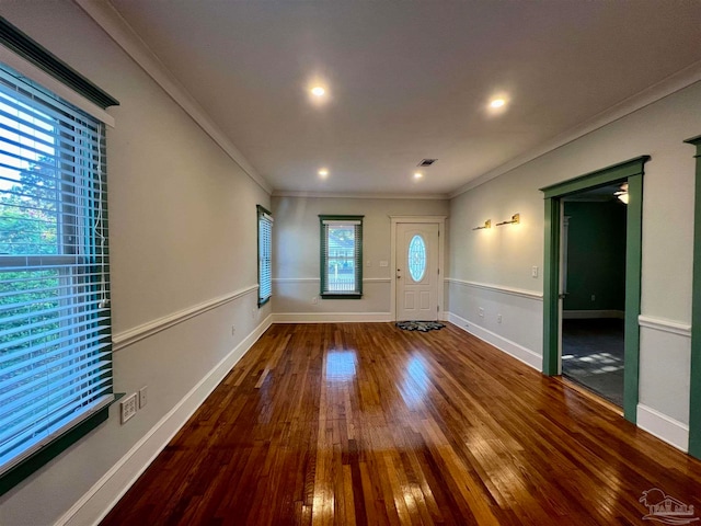 foyer with crown molding and hardwood / wood-style flooring