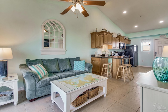 tiled living room with high vaulted ceiling, sink, and ceiling fan