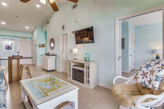 tiled living room with high vaulted ceiling and ceiling fan