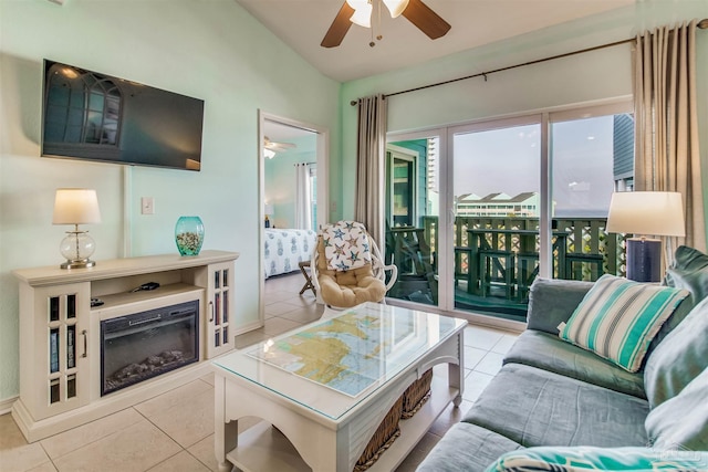 living room featuring light tile patterned flooring, ceiling fan, and vaulted ceiling