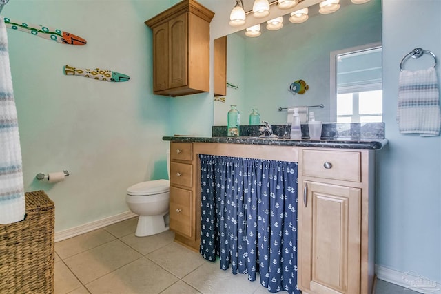 bathroom with vanity, tile patterned floors, and toilet